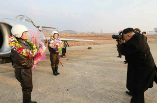Illustration for article titled Kim Jong Un Visits Female Fighter Pilots, Picks Up Camera For Photo Op